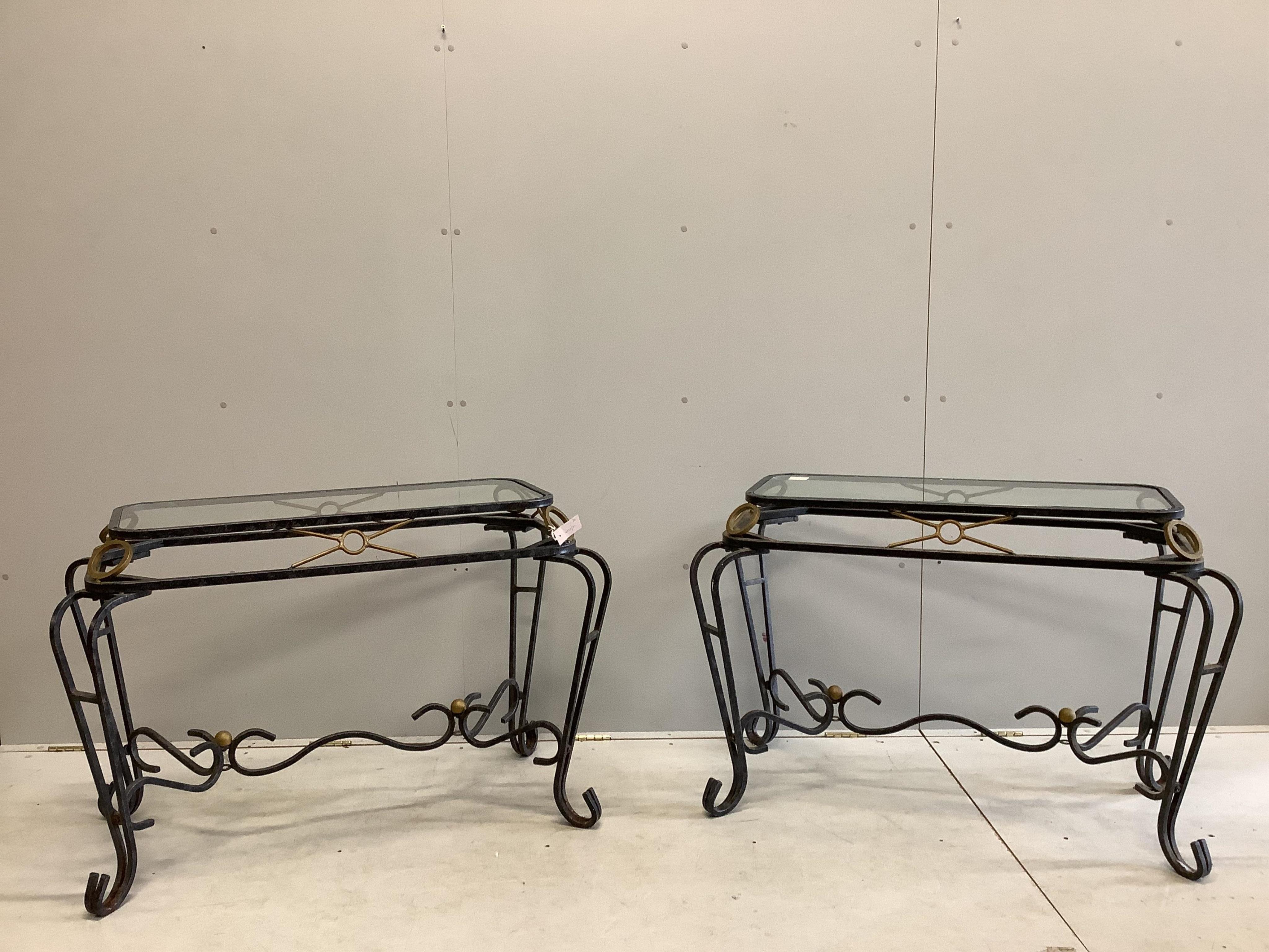 A pair of wrought iron glass top tables, width 106cm, depth 58cm, height 71cm. Condition - fair